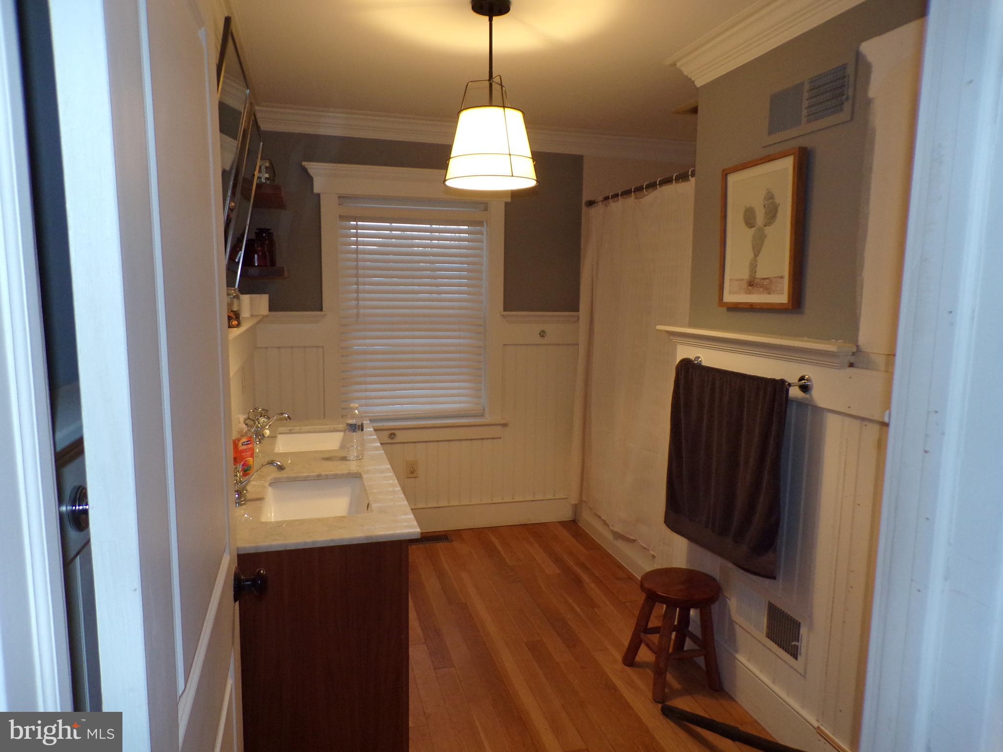 3316 Stoudts Ferry Bridge Road Reading, PA 19605 - Photo 10 of 18 a bathroom with a sink a mirror and window