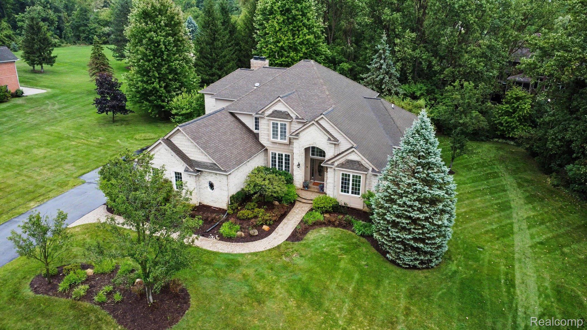 4875 Green Meadow Lane Rochester, MI 48306 - Photo 59 of 60 Stone and siding exterior with multi-level roofing