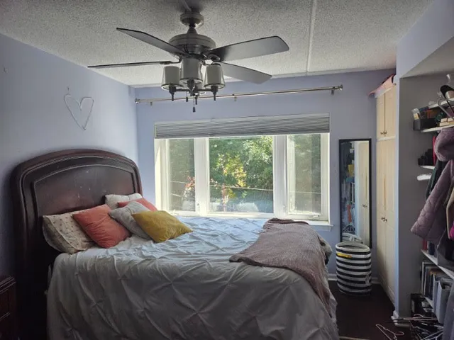 a bedroom with a bed and a chandelier
