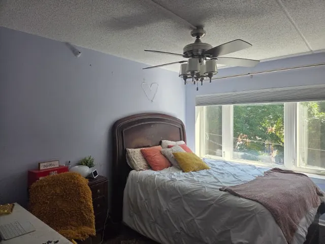 a bedroom with a bed and a window