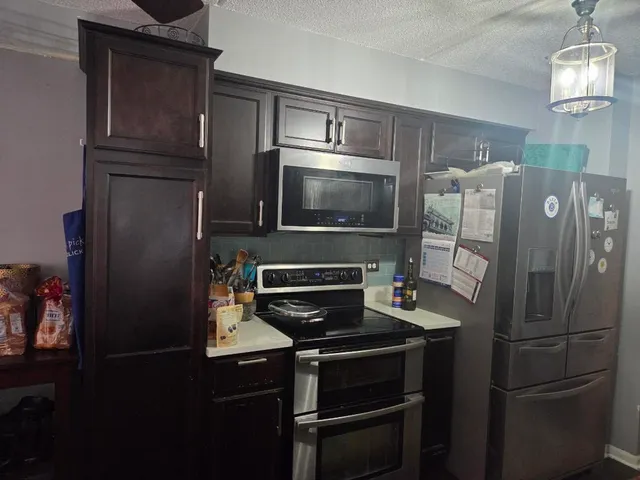 a kitchen with a refrigerator stove and microwave