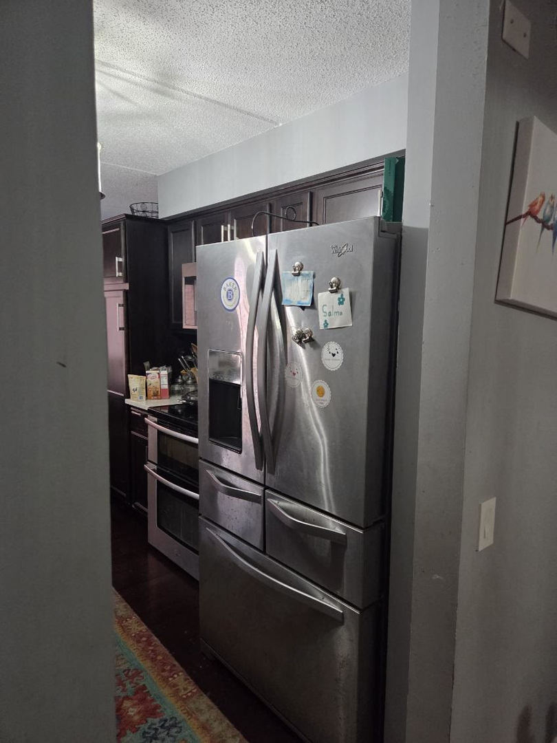 811 Chicago Avenue, Unit 308 Evanston, IL 60202 - Photo 15 of 18 a metallic refrigerator freezer sitting in a kitchen