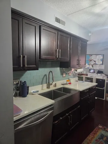 a kitchen with a sink and cabinets