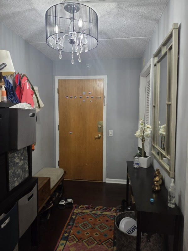 811 Chicago Avenue, Unit 308 Evanston, IL 60202 - Photo 17 of 18 a bedroom with a bed and a chandelier