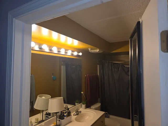 a bathroom with a mirror and a sink