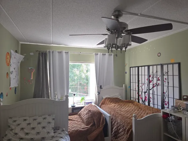 a bedroom with a bed and a chandelier