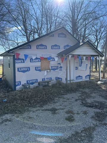 a view of a blue house with a yard