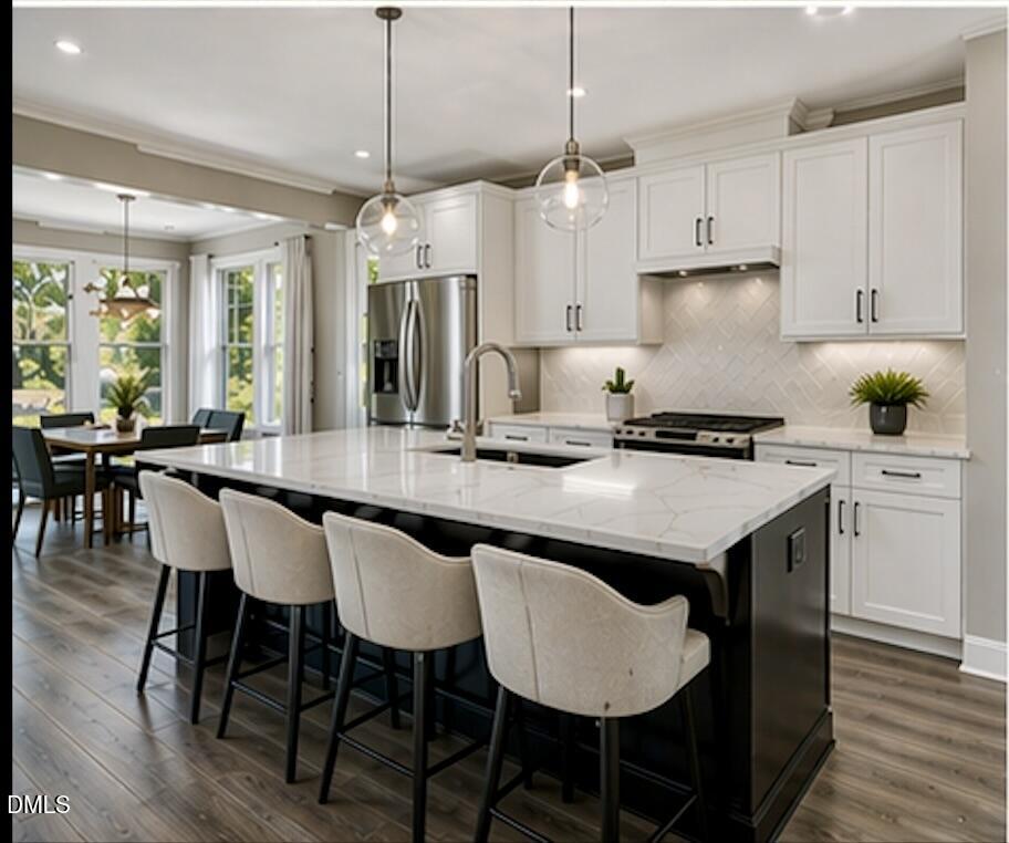 405 Alston Street Raleigh, NC 27601 - Photo 2 of 14 a kitchen with granite countertop a table chairs stove and white cabinets