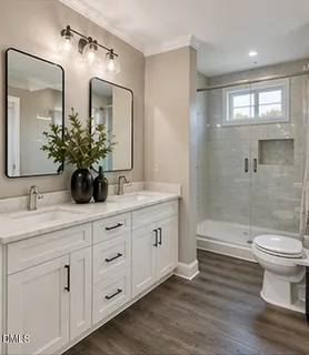 a bathroom with a double vanity sink toilet and shower