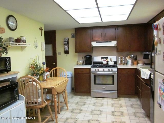 1483 Brislin Road Stroudsburg, PA 18360 - Photo 19 of 37 a kitchen with stainless steel appliances a stove a sink and a refrigerator