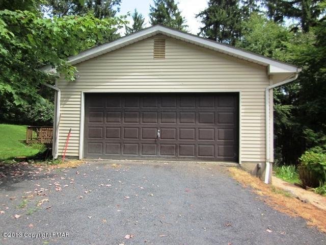 1483 Brislin Road Stroudsburg, PA 18360 - Photo 28 of 37 a front view of a house with a yard and garage