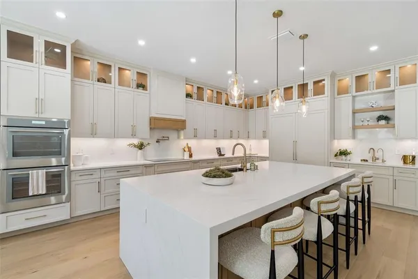 a kitchen with a sink a stove and cabinets