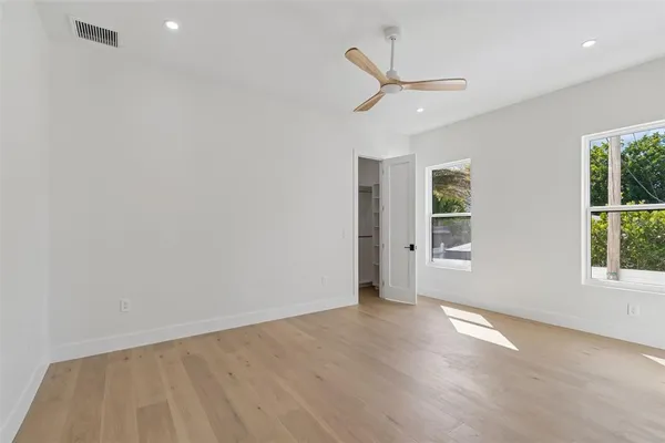 a spacious bathroom with a double vanity sink a mirror and a bathtub