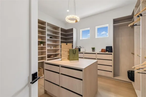 an empty room with a window and a ceiling fan