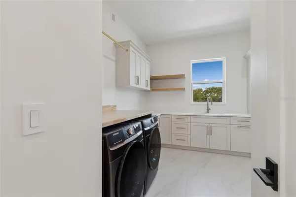 a kitchen with stainless steel appliances a stove a sink and a refrigerator