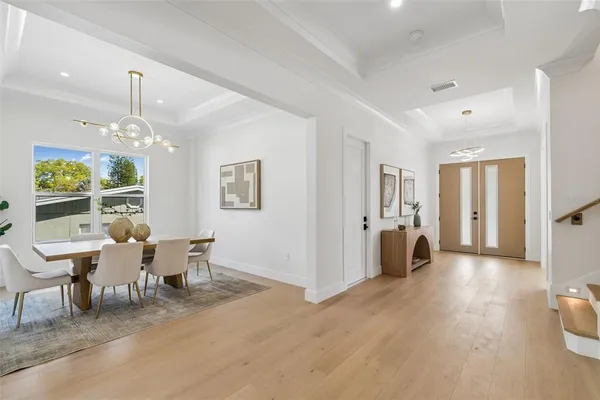 a view of a dining room with furniture wooden floor and chandelier