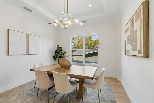 a dining room with furniture and chandelier