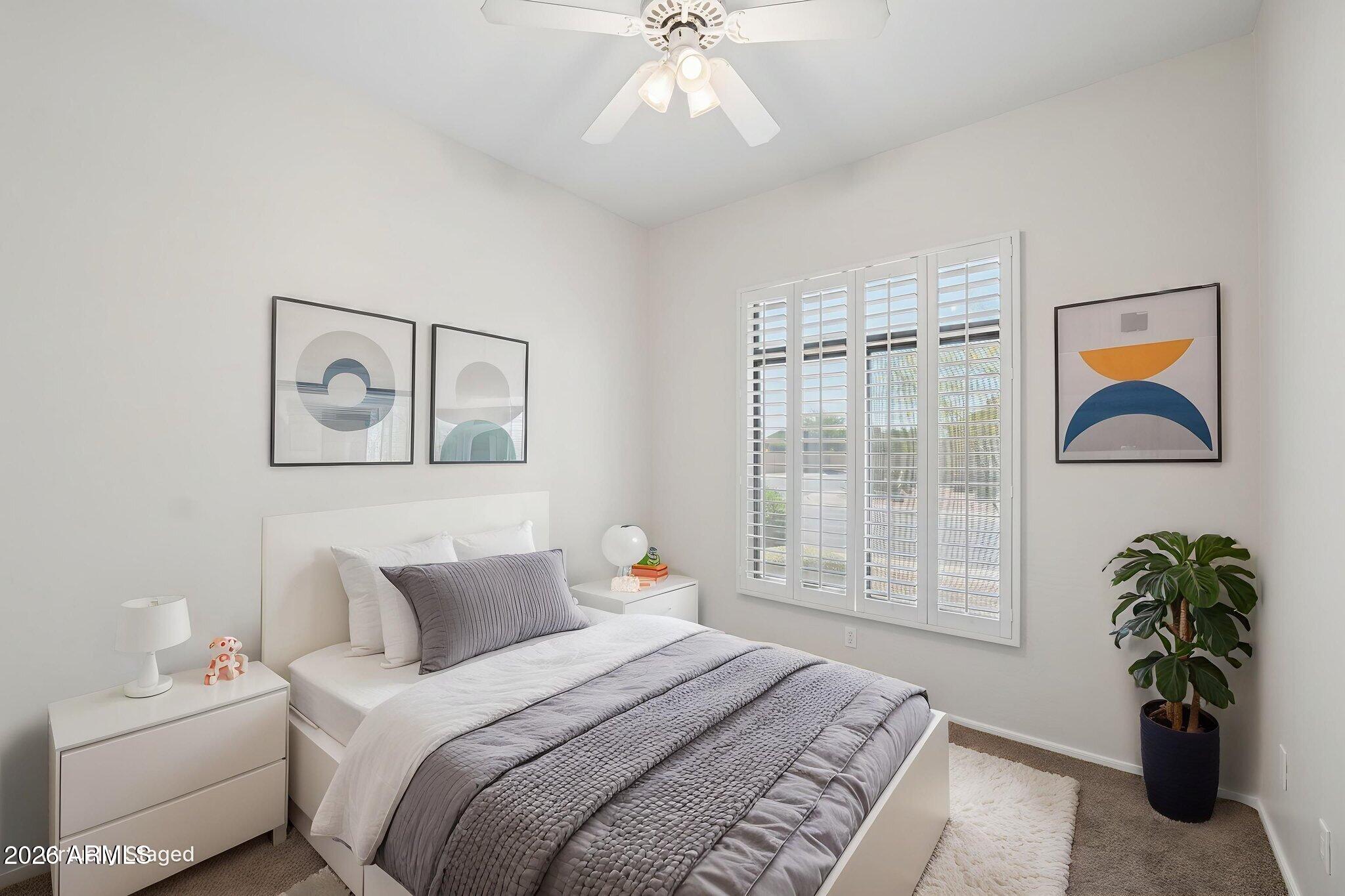 4418 East Jaeger Road Phoenix, AZ 85050 - Photo 29 of 42 a bedroom with a balcony a bed and a chandelier