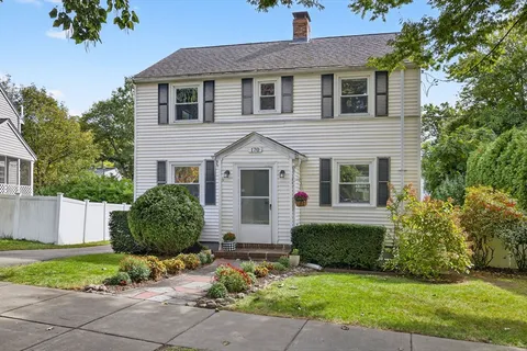 a view of a house with a yard and plants