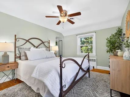 a bedroom with a bed and a ceiling fan