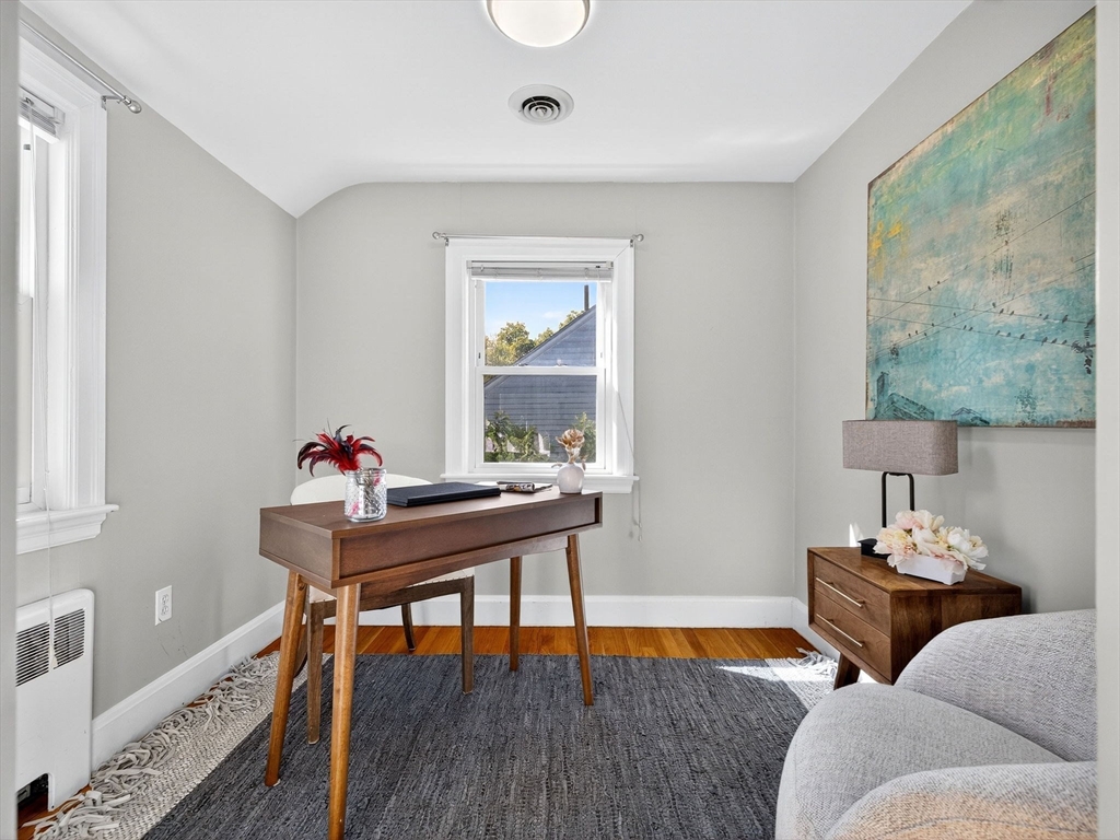 170 Payson Road Boston, MA 02467 - Photo 15 of 20 a living room with furniture and a wooden floor