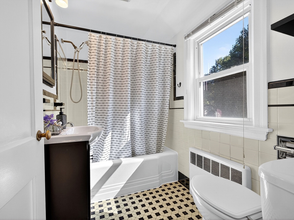 170 Payson Road Boston, MA 02467 - Photo 16 of 20 a bathroom with a sink a toilet and shower