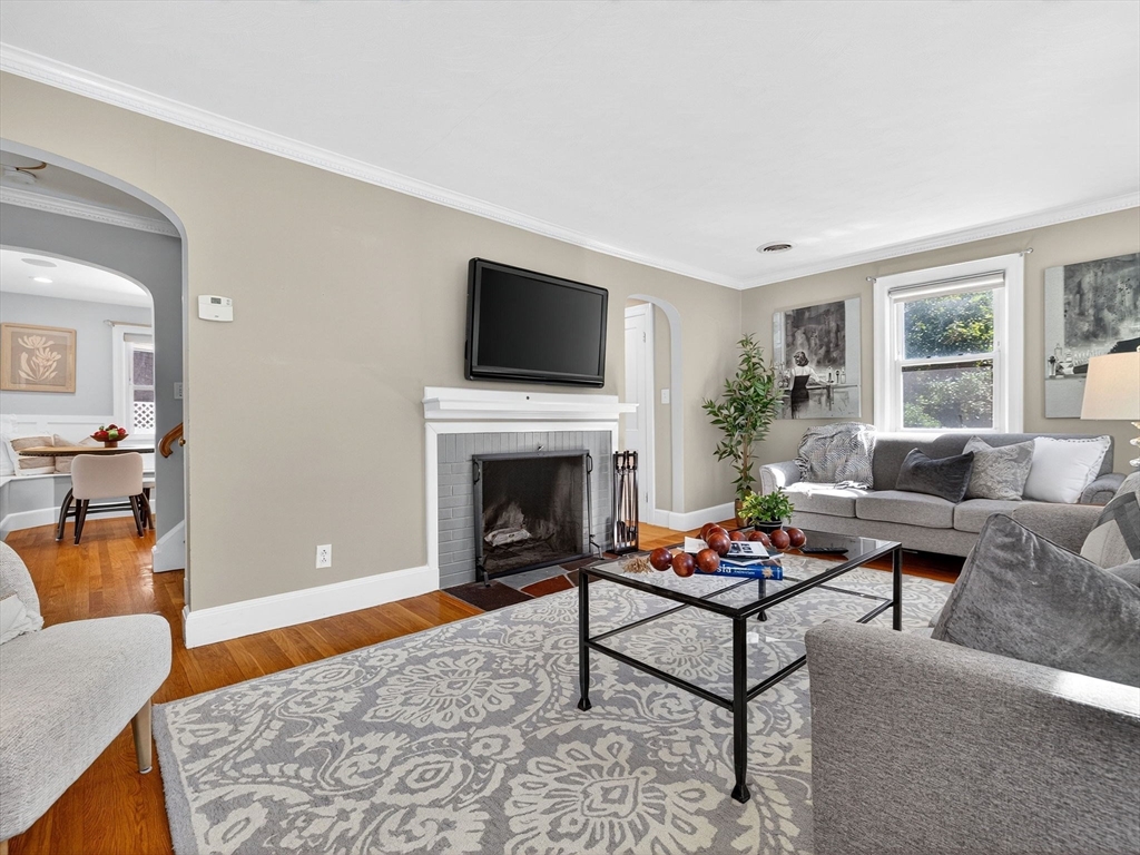 170 Payson Road Boston, MA 02467 - Photo 4 of 20 a living room with furniture a rug and a fireplace