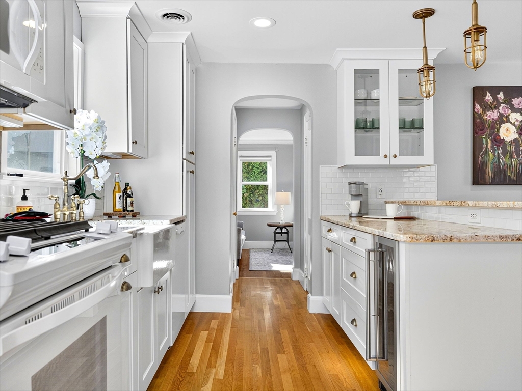 170 Payson Road Boston, MA 02467 - Photo 8 of 20 a kitchen with granite countertop a sink stove and cabinets