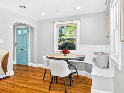 a view of a dining room with furniture window and wooden floor