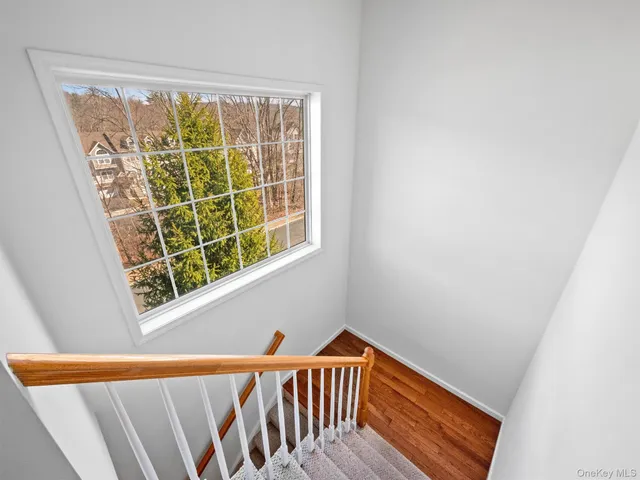a view of a room with wooden floor and windows