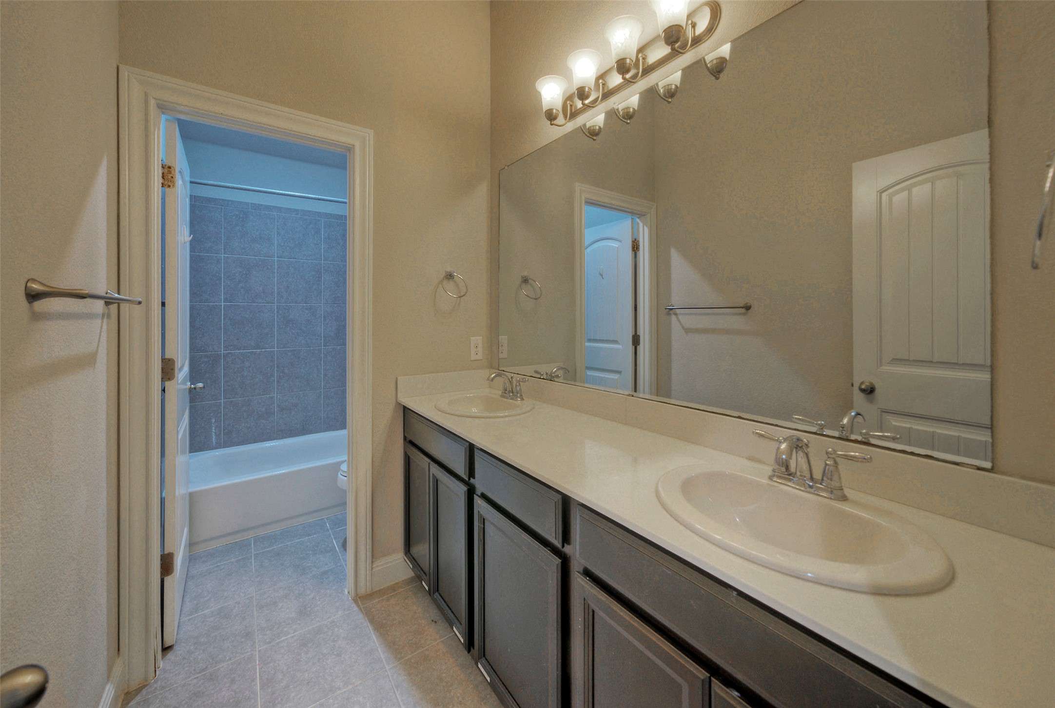 2260 Hat Bender Loop Round Rock, TX 78664 - Photo 26 of 40 Double vanity sinks and bright lighting adorn this bathroom, offering ample space.