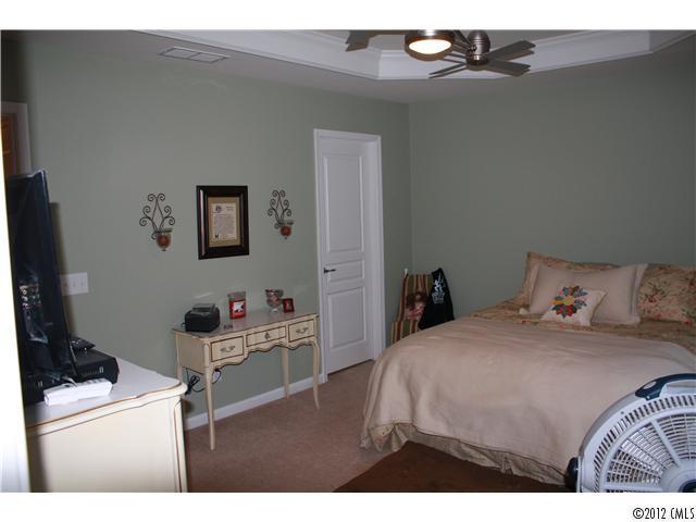 706 Passage Drive, Unit 31 Fort Mill, SC 29708 - Photo 11 of 16 a bedroom with a bed and a cabinets