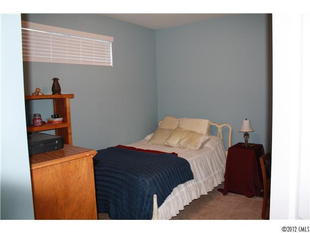 706 Passage Drive, Unit 31 Fort Mill, SC 29708 - Photo 13 of 16 a bedroom with a bed and a cabinets