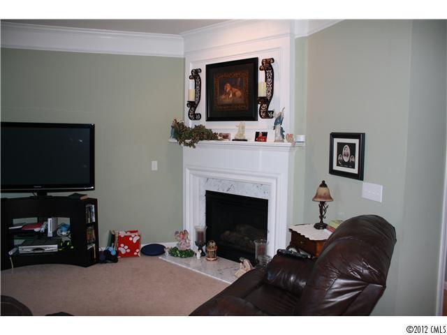 706 Passage Drive, Unit 31 Fort Mill, SC 29708 - Photo 6 of 16 a living room with furniture a flat screen tv and a fireplace