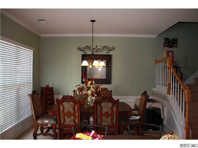 706 Passage Drive, Unit 31 Fort Mill, SC 29708 - Photo 9 of 16 a view of a dining room with furniture and chandelier