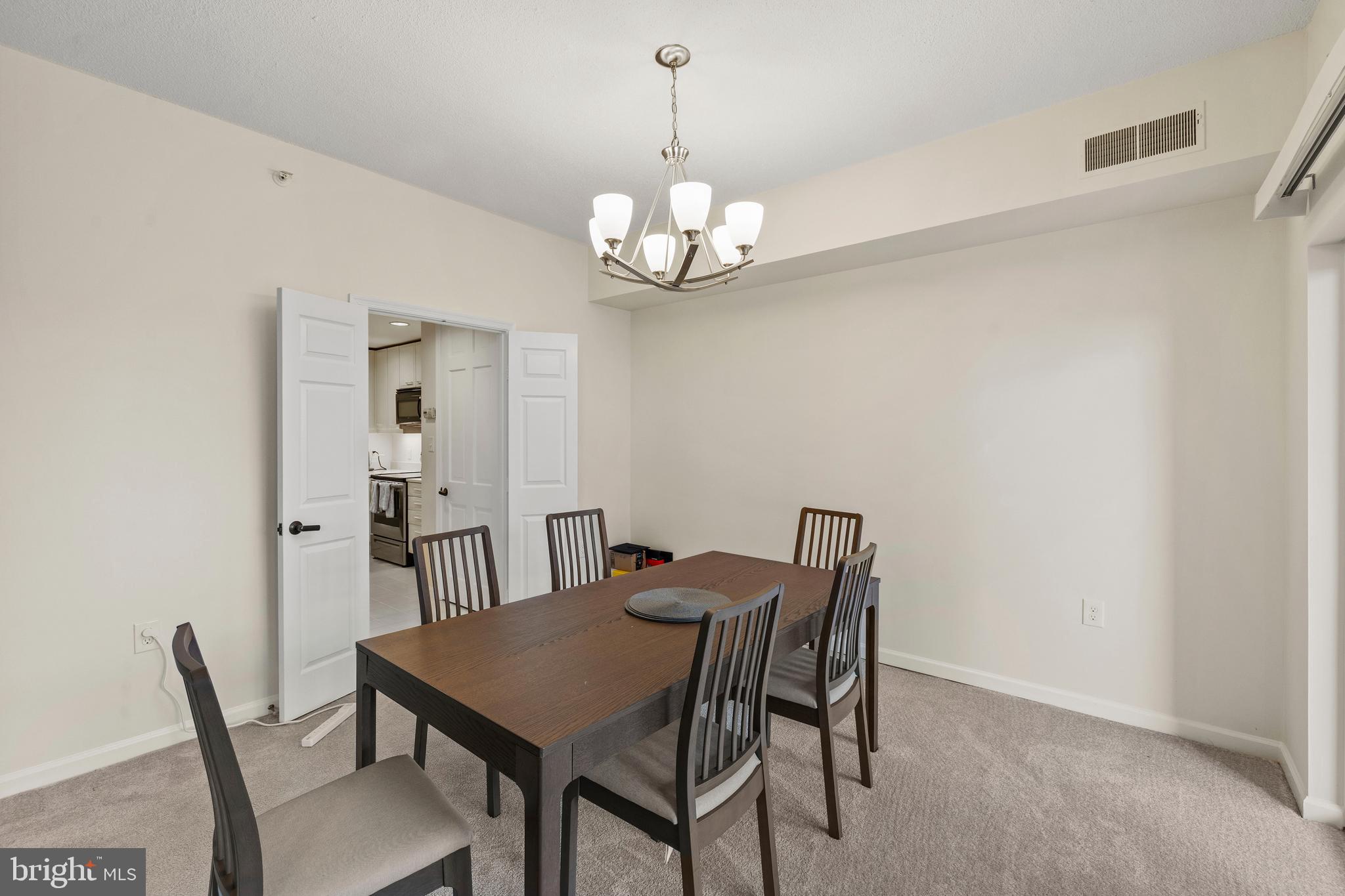 3801 Canterbury Road, Unit 708 Baltimore, MD 21218 - Photo 11 of 22 a view of a dining room with a table and chairs