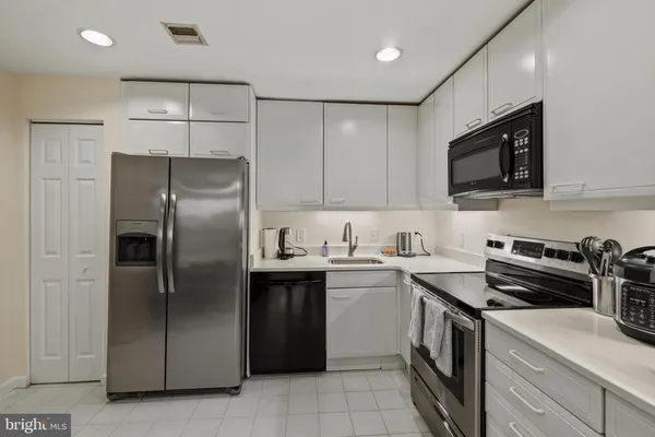 a kitchen with stainless steel appliances granite countertop a stove and a refrigerator