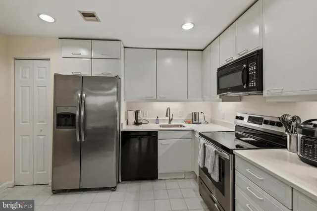 a kitchen with stainless steel appliances granite countertop a stove and a refrigerator