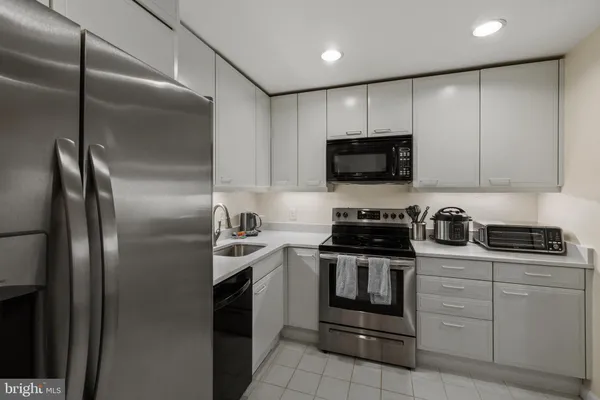 a bathroom with a sink vanity granite and a mirror