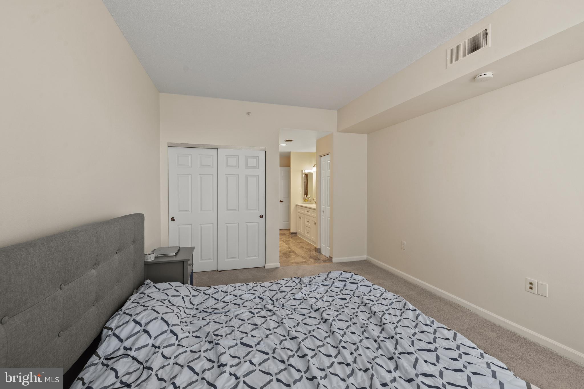 3801 Canterbury Road, Unit 708 Baltimore, MD 21218 - Photo 22 of 22 a bedroom with a bed and a cabinets