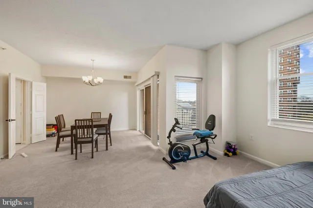 a view of a dining room with a table and chairs