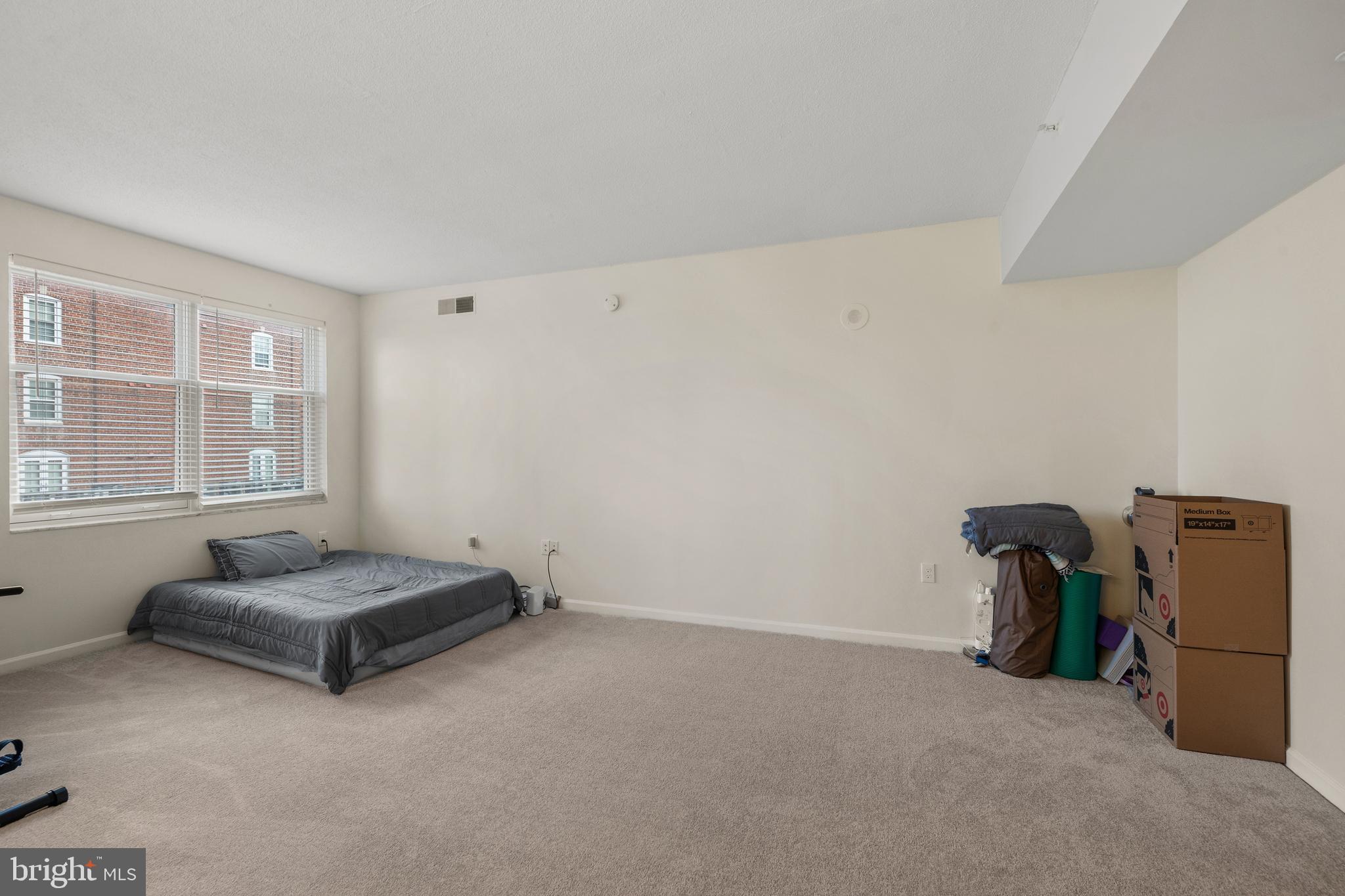 3801 Canterbury Road, Unit 708 Baltimore, MD 21218 - Photo 10 of 22 a living room with furniture and a window