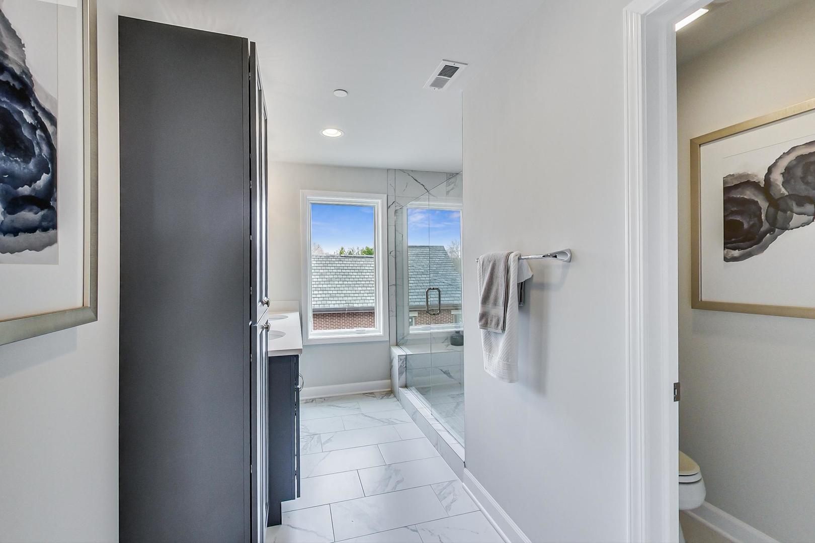 1261 Shermer Road Northbrook, IL 60062 - Photo 16 of 33 a bathroom with a sink a toilet and a shower