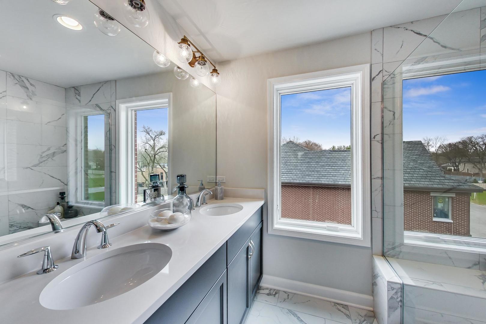 1261 Shermer Road Northbrook, IL 60062 - Photo 17 of 33 a bathroom with a sink double vanity and a large mirror