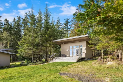 a view of a house with backyard porch and sitting area
