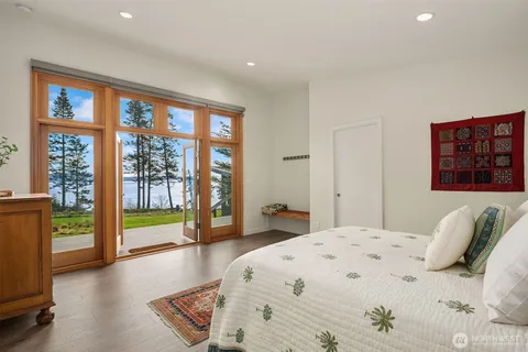 a bedroom with a large bed and a large window