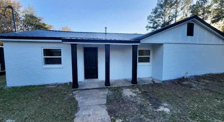 1853 Wadsworth Road Baker, FL 32531 - Photo 1 of 5 a front view of a house with garden