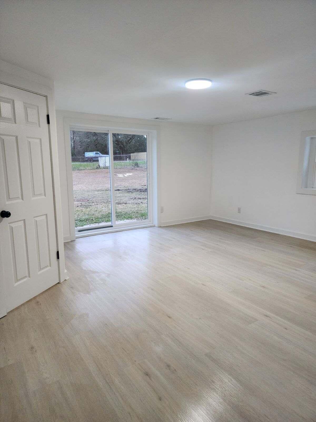 1853 Wadsworth Road Baker, FL 32531 - Photo 3 of 5 a view of an empty room with a fireplace