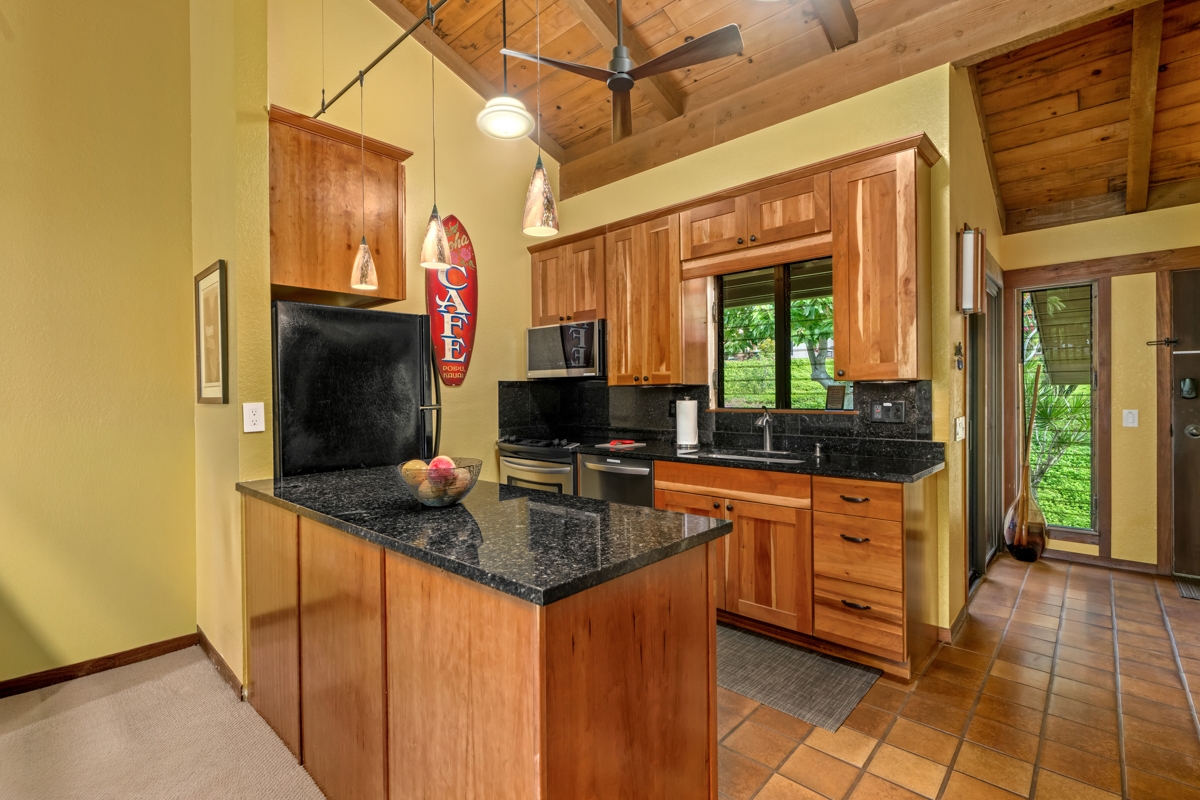 1870 Hoone Road, Unit 602 Koloa, HI 96756 - Photo 4 of 26 a kitchen with stainless steel appliances granite countertop a sink and a refrigerator