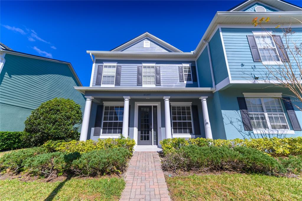 10187 Ridgebloom Avenue Orlando, FL 32829 - Photo 1 of 1 a front view of a house with garden